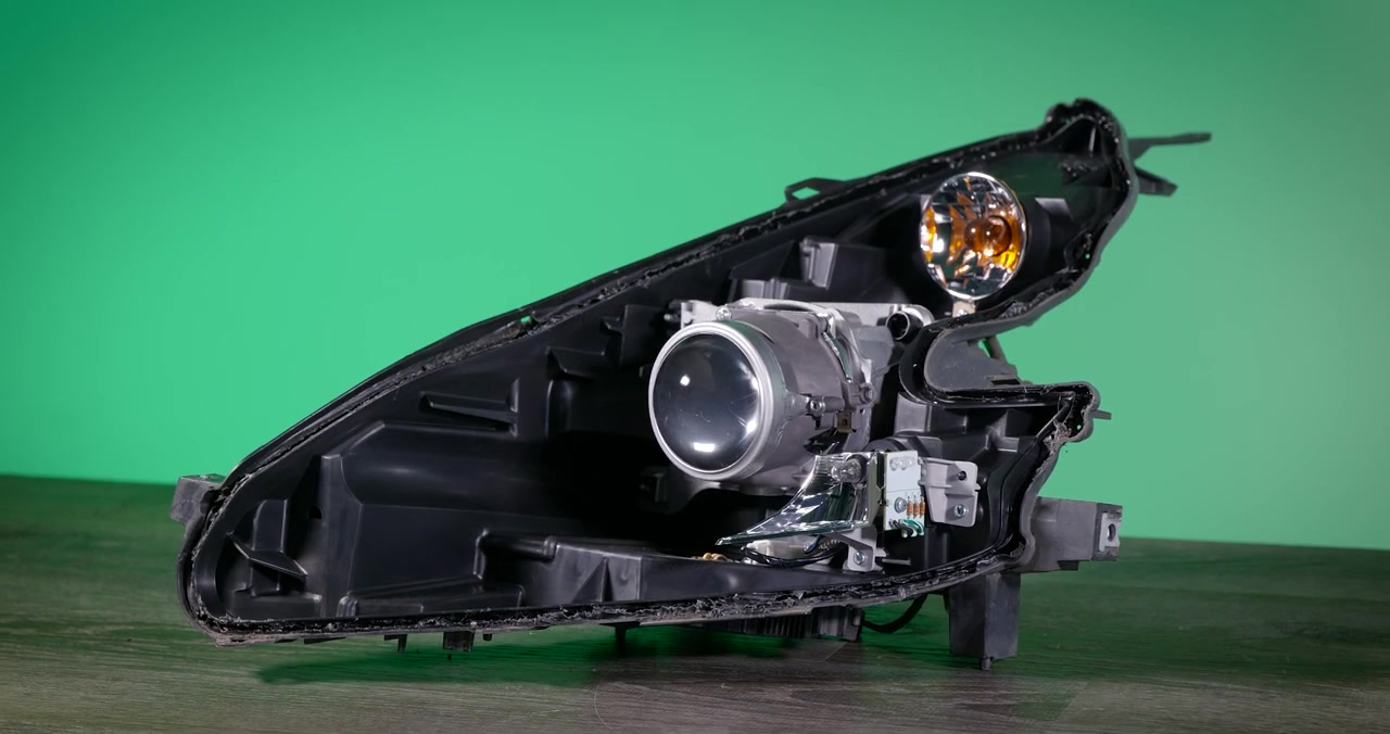 370Z headlight internals exposed after lens removal showing projector assembly