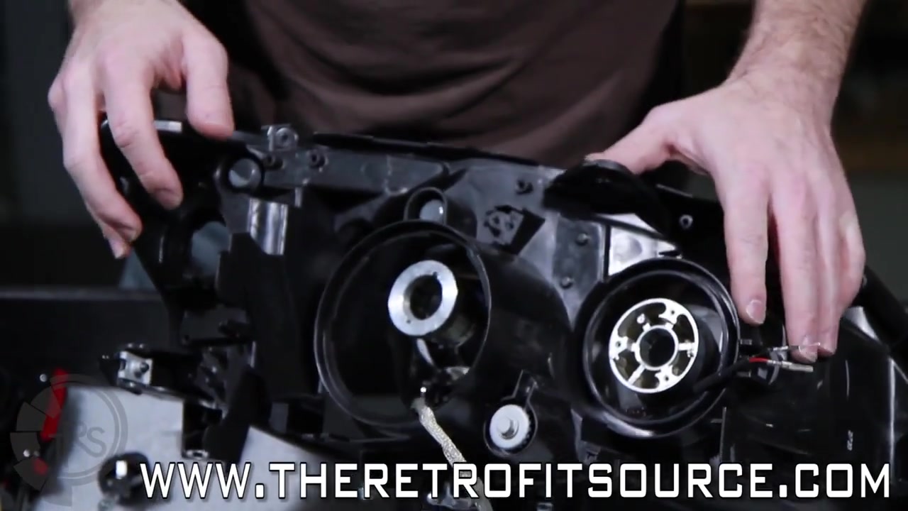 Metal and rubber O-rings being installed on bi-xenon bulb